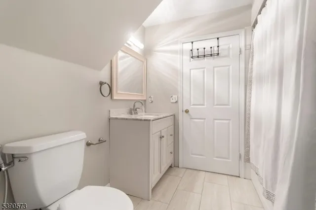 a bathroom with a toilet sink and a mirror