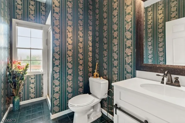 a bathroom with a toilet sink and shower curtain