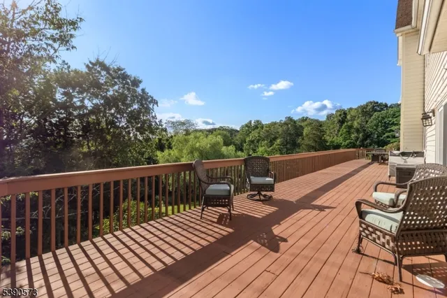 a view of balcony with wooden floor and outdoor seating