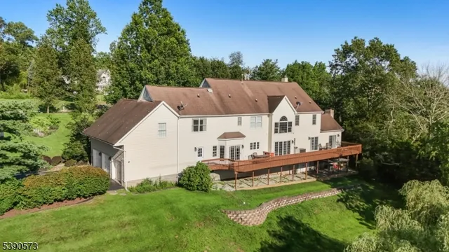 a view of a house with a yard and deck