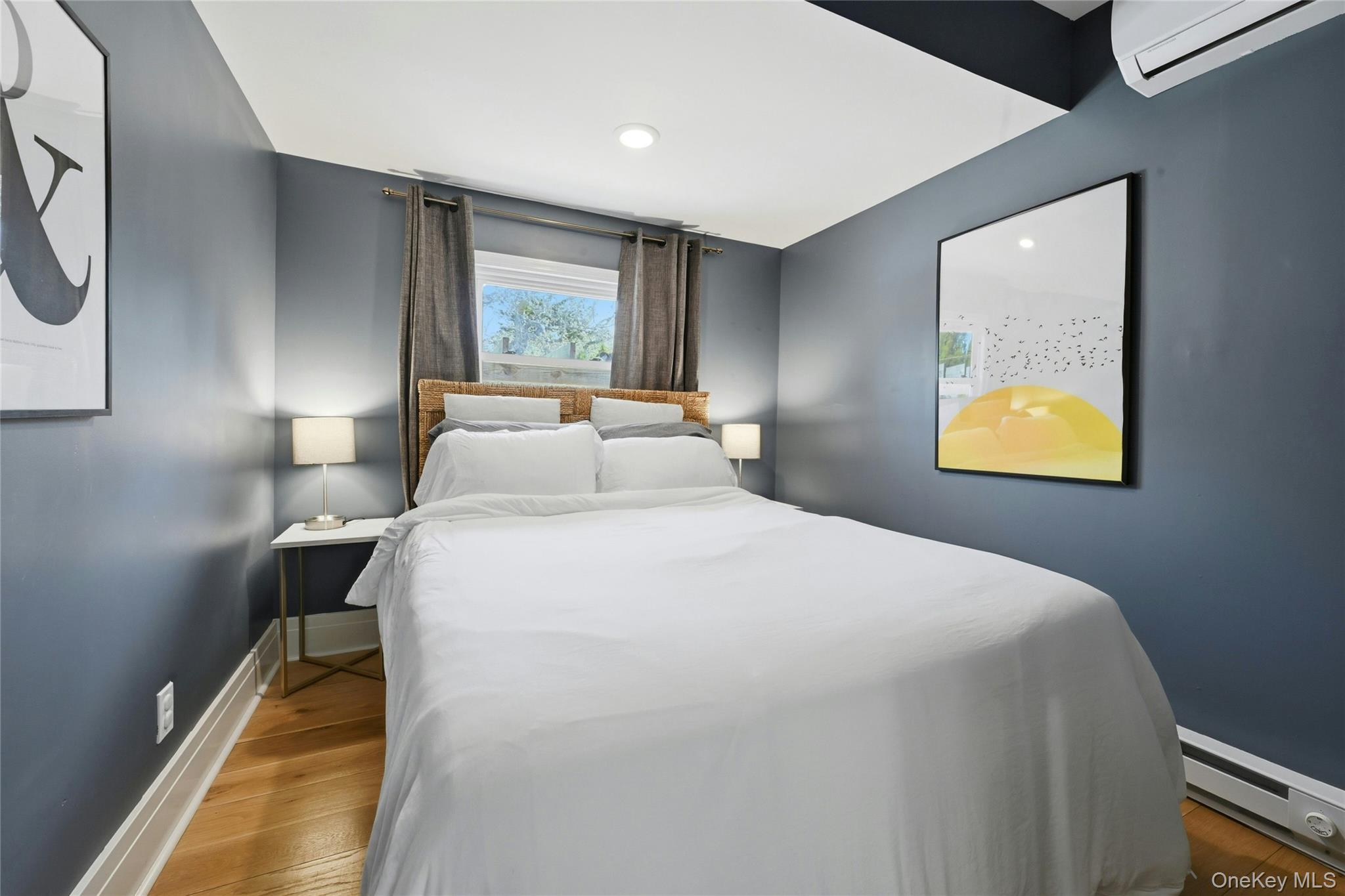 46 Beach Road Laurel, NY 11948 - Photo 11 of 24 a bedroom with a bed and a window