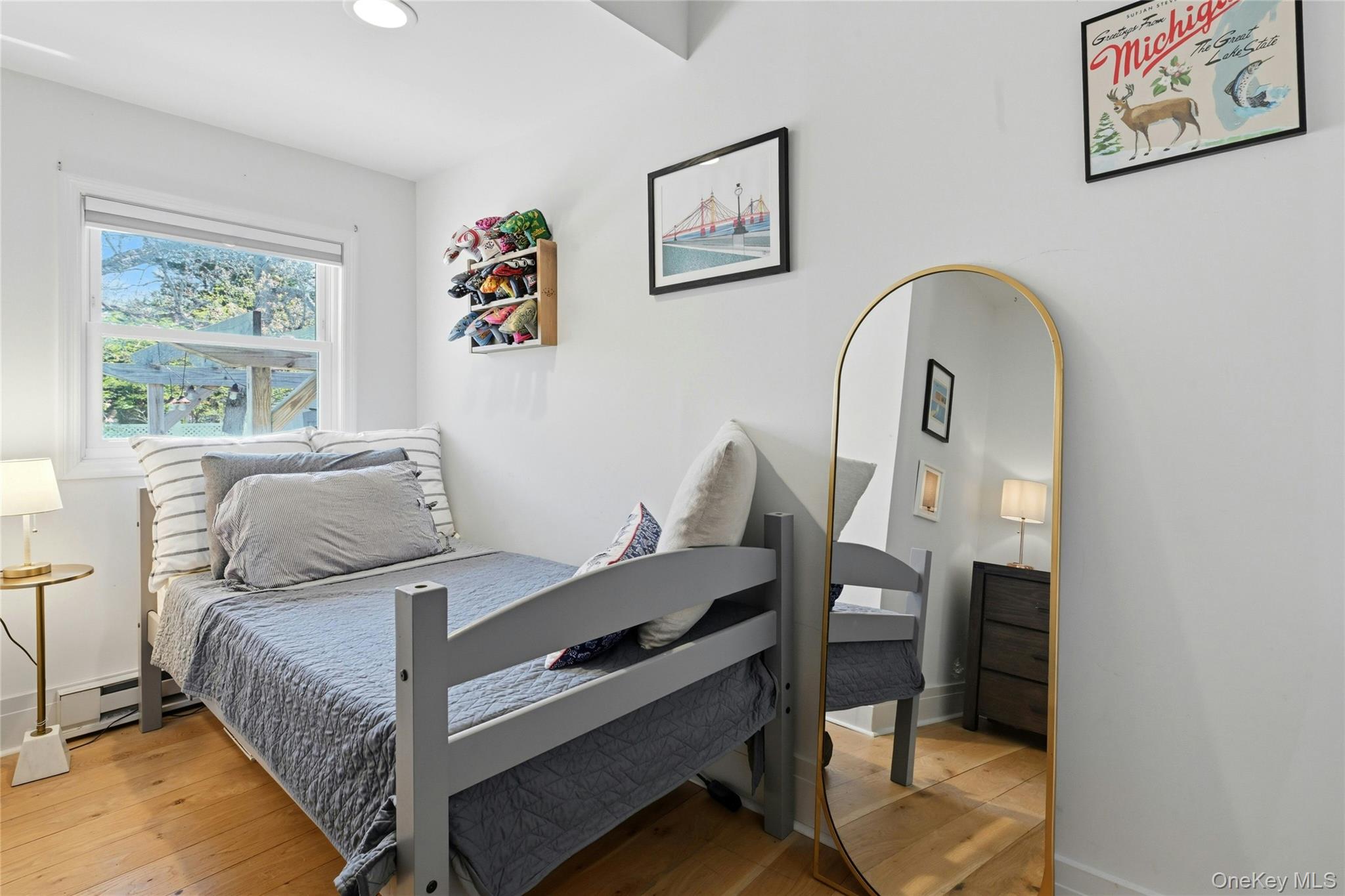 46 Beach Road Laurel, NY 11948 - Photo 12 of 24 a bed room with a bed and a painting on the wall