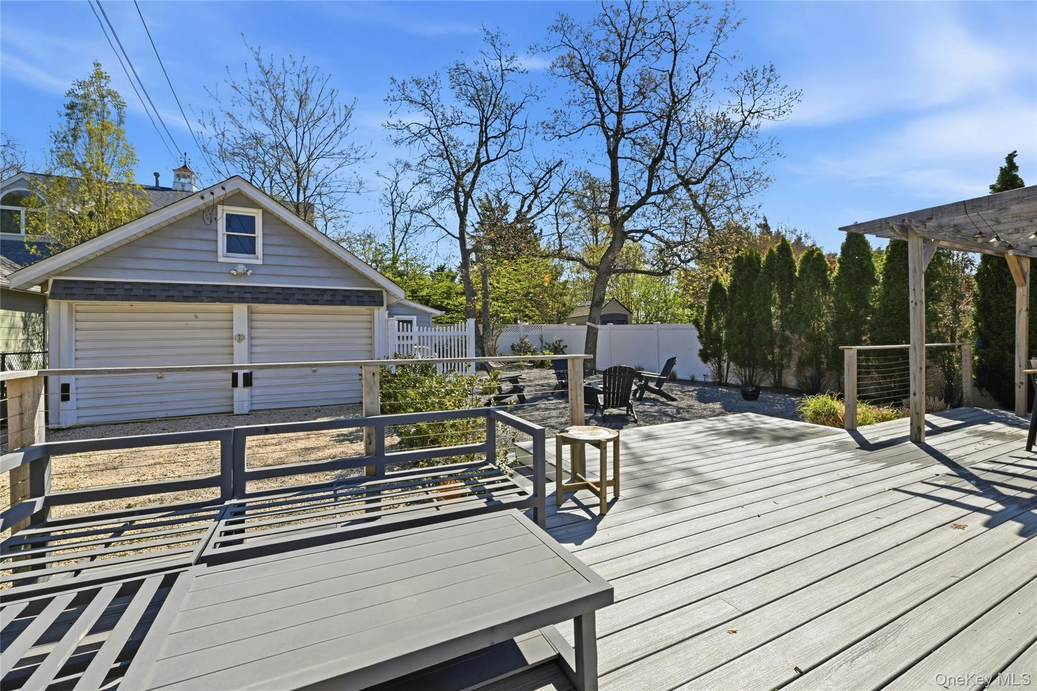 46 Beach Road Laurel, NY 11948 - Photo 15 of 24 a view of a roof deck with table and chairs and wooden floor