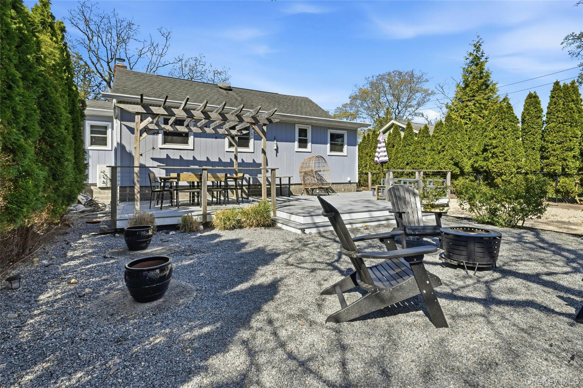 46 Beach Road Laurel, NY 11948 - Photo 18 of 24 a view of a patio with dining table and chairs with plants