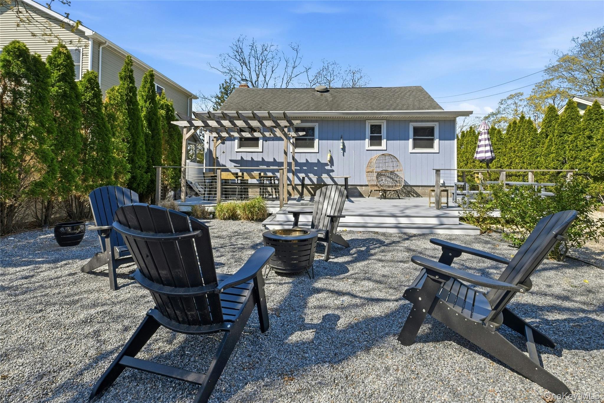 46 Beach Road Laurel, NY 11948 - Photo 19 of 24 a view of a patio with table and chairs and potted plants