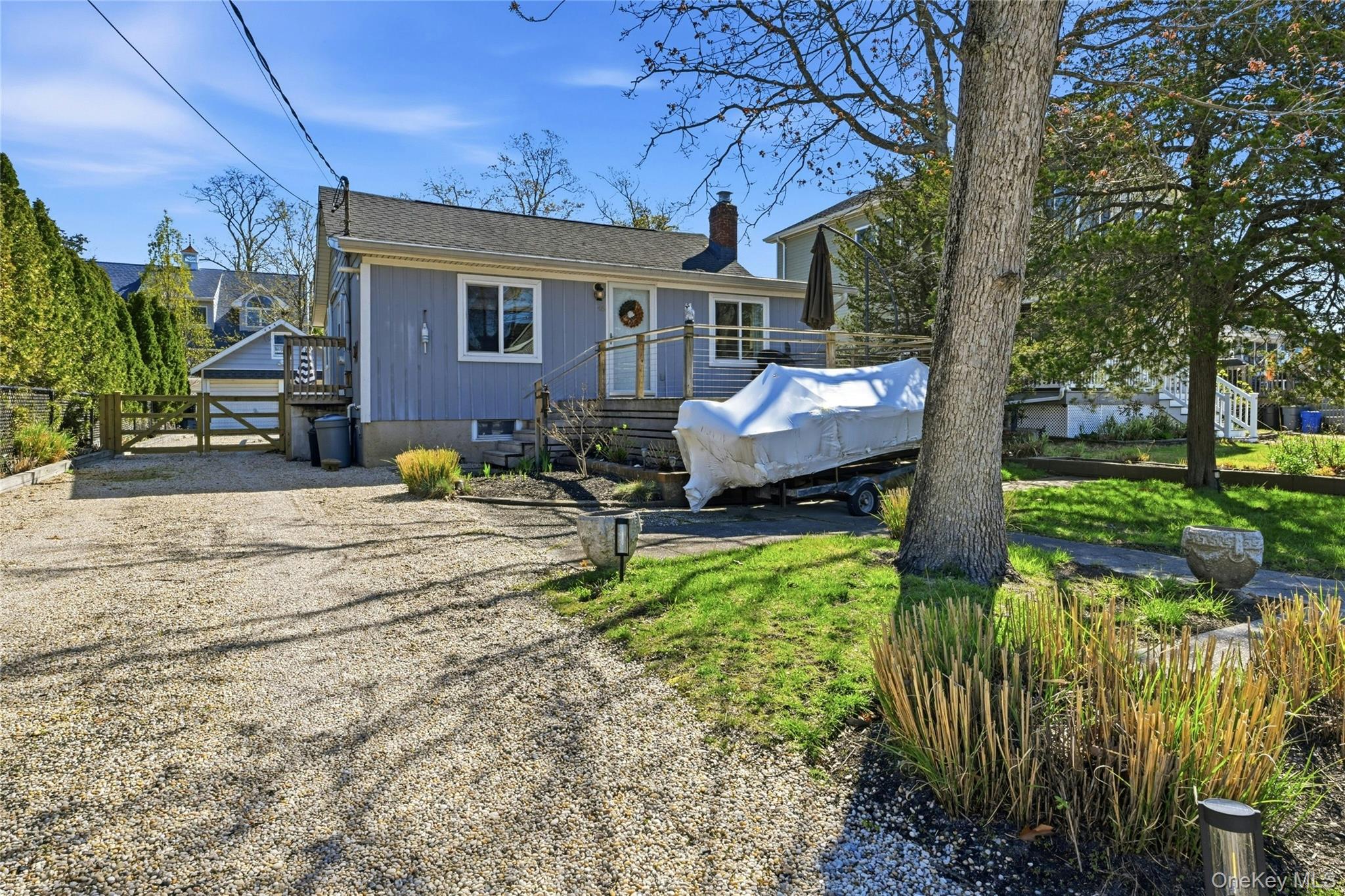 46 Beach Road Laurel, NY 11948 - Photo 20 of 24 a front view of a house with garden