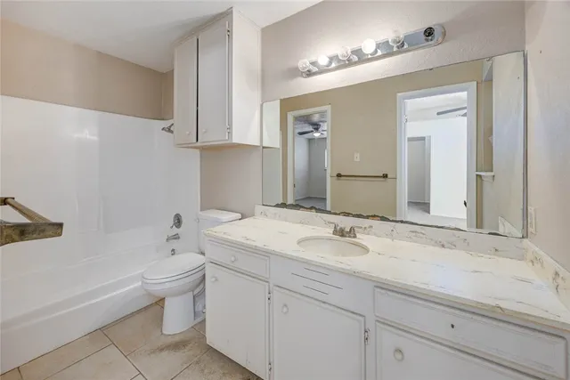 a bathroom with a sink a toilet and bathtub