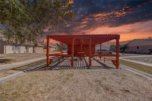 a view of a wooden deck next to a yard