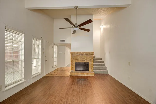 wooden floor in an empty room with a fireplace