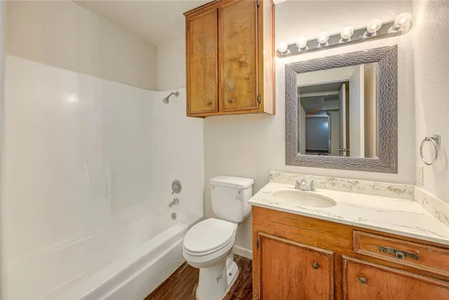 a bathroom with a sink a toilet and vanity
