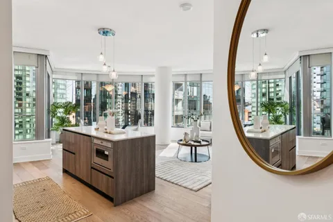 a view of living room with furniture and large windows