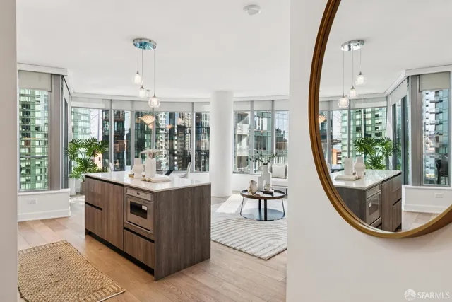a view of living room with furniture and large windows