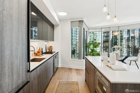 a kitchen with kitchen island a sink stainless steel appliances and cabinets