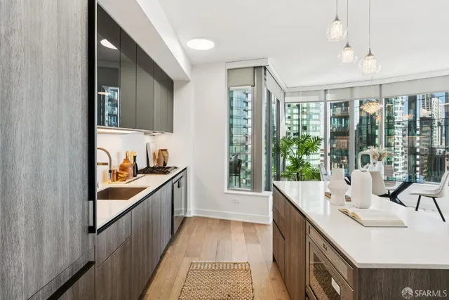 a kitchen with kitchen island a sink stainless steel appliances and cabinets