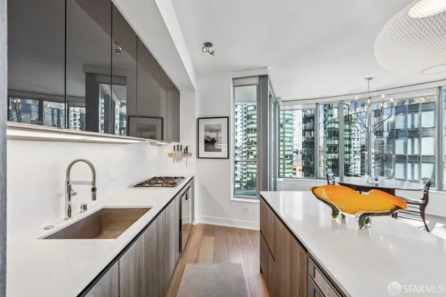 a kitchen with blue cabinets a sink a stove and a refrigerator