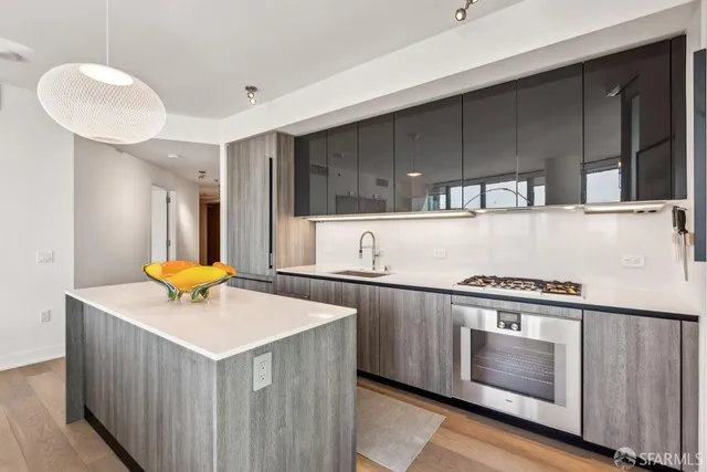 a kitchen with stainless steel appliances a stove a sink and a microwave