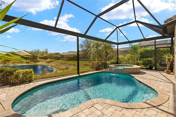 a view of swimming pool with a lounge chairs