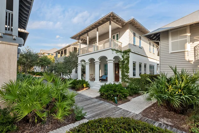 a front view of a house with a garden