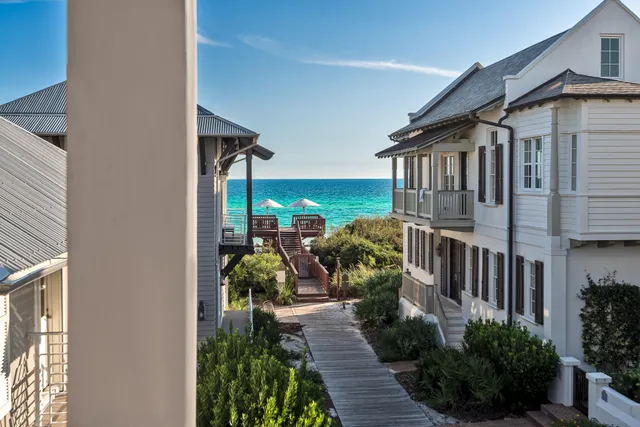 a front view of a house with outdoor seating and plants