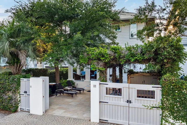 a view of a house next to a big yard with a fountain