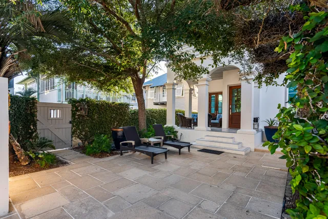 a view of a house with swimming pool and a chairs