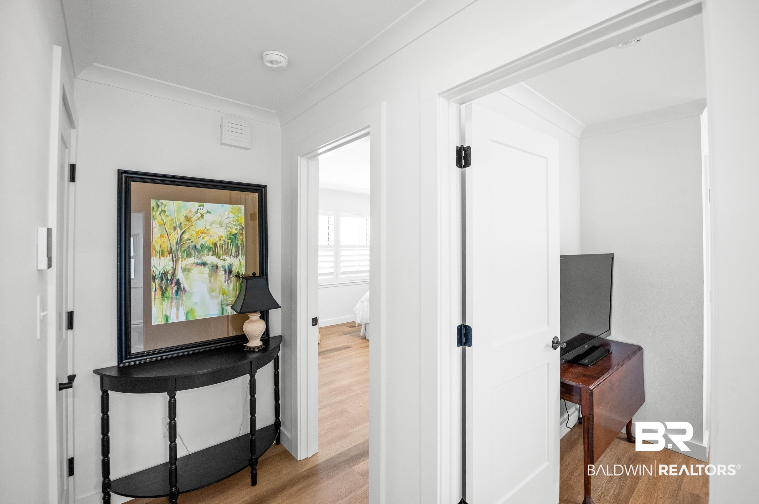 9459 Soldier Creek Road Lillian, AL 36549 - Photo 18 of 54 Hall with ornamental molding, baseboards, and light wood finished floors