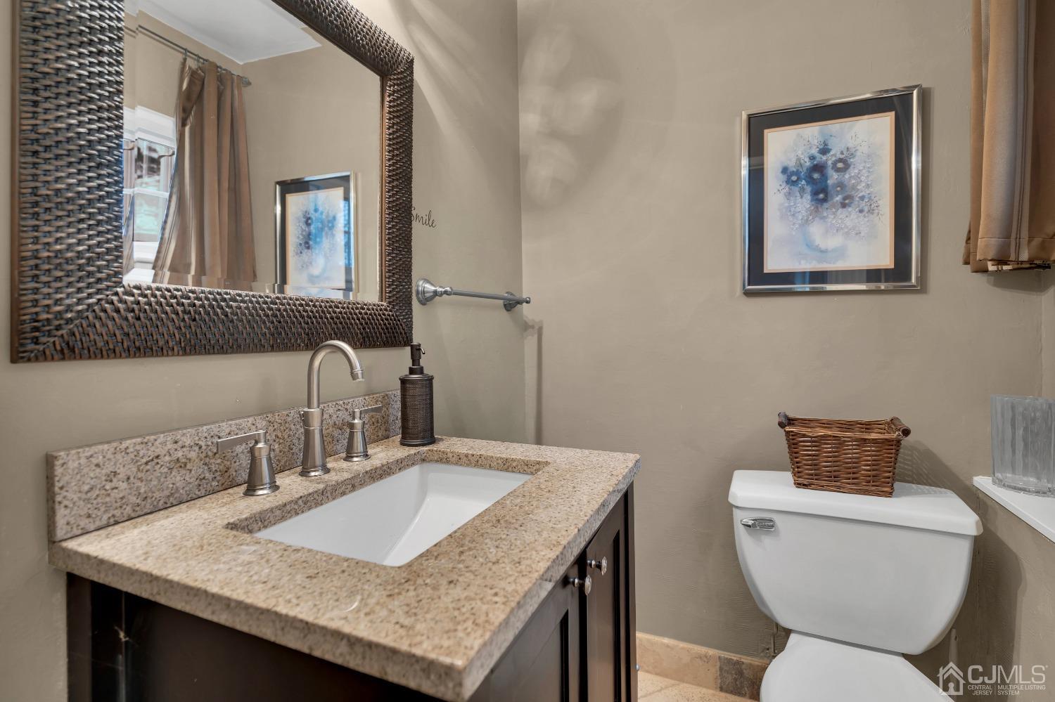 19 Calvin Court Old Bridge, NJ 08857 - Photo 16 of 25 a bathroom with a toilet a sink and a mirror