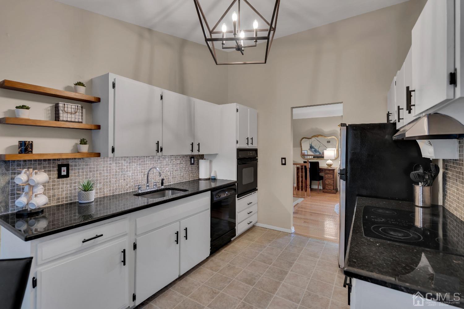 19 Calvin Court Old Bridge, NJ 08857 - Photo 7 of 25 a kitchen with stainless steel appliances granite countertop a sink and cabinets