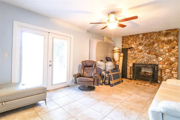 a living room with furniture a fireplace and a chandelier