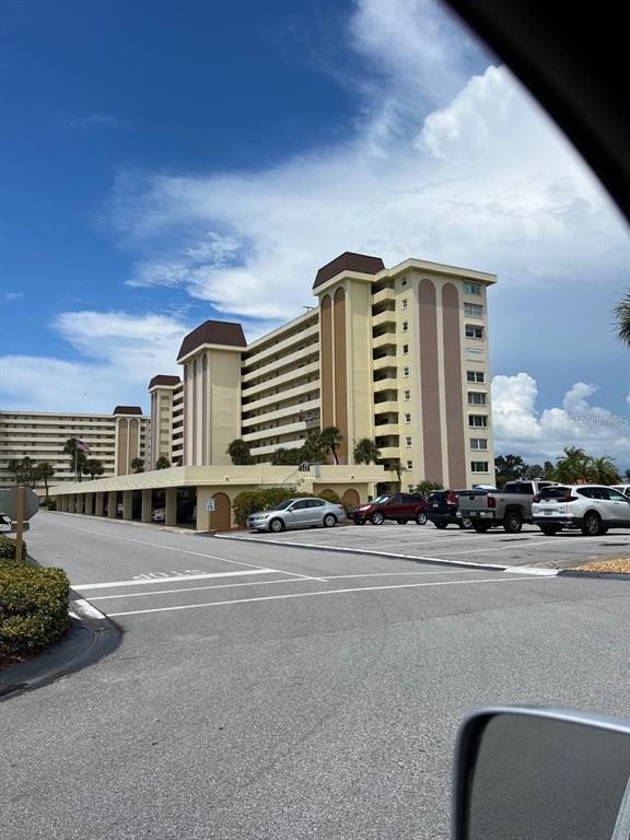 4725 Cove Circle, Unit 108 St. Petersburg, FL 33708 - Photo 1 of 14 a view of a building with car parked