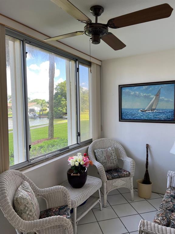 4725 Cove Circle, Unit 108 St. Petersburg, FL 33708 - Photo 11 of 14 a living room with furniture and a large window