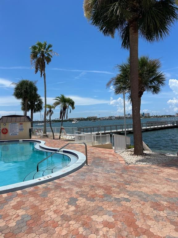 4725 Cove Circle, Unit 108 St. Petersburg, FL 33708 - Photo 13 of 14 a view of a swimming pool with a yard