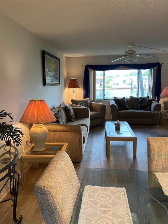 4725 Cove Circle, Unit 108 St. Petersburg, FL 33708 - Photo 3 of 14 a living room with furniture and a large window