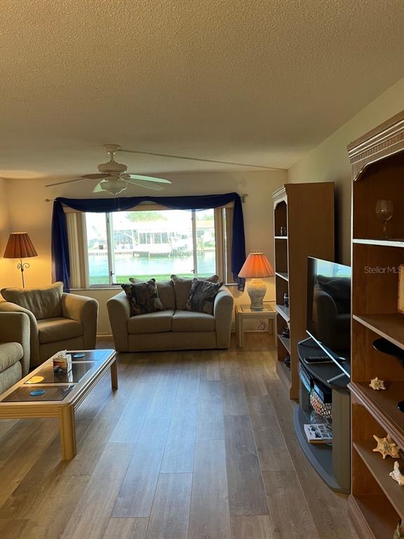 4725 Cove Circle, Unit 108 St. Petersburg, FL 33708 - Photo 5 of 14 a living room with furniture and a flat screen tv