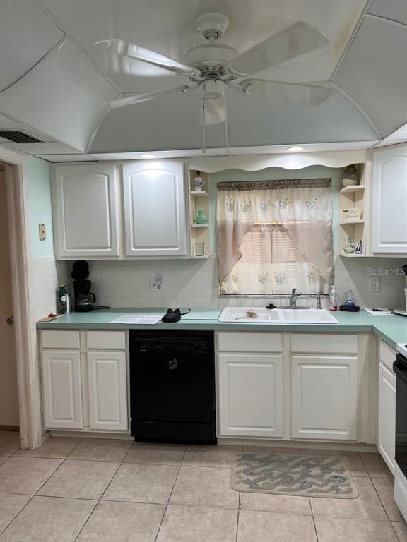 4725 Cove Circle, Unit 108 St. Petersburg, FL 33708 - Photo 9 of 14 a kitchen with a sink and cabinets