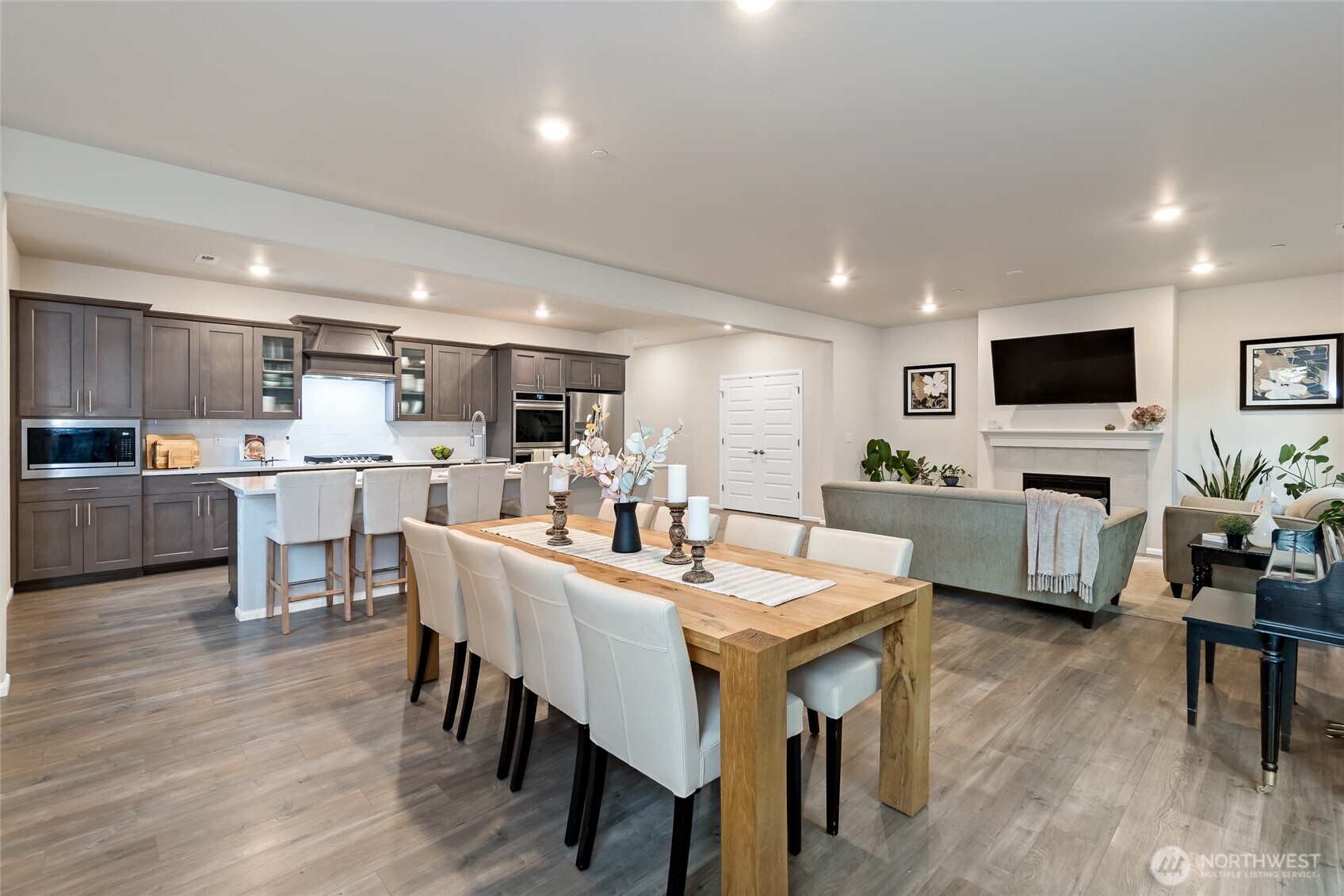4122 235th Place Southeast Bothell, WA 98021 - Photo 13 of 40 a kitchen with a dining table chairs refrigerator and microwave