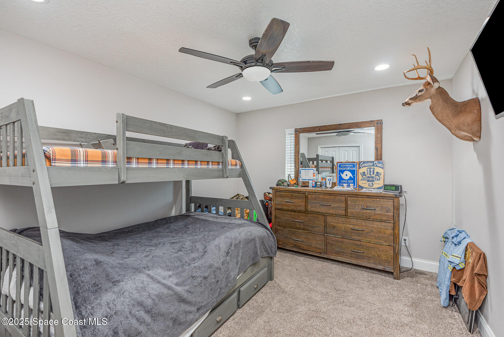 3620 Maebert Road Mims, FL 32754 - Photo 22 of 35 a bedroom with a bed and a chandelier