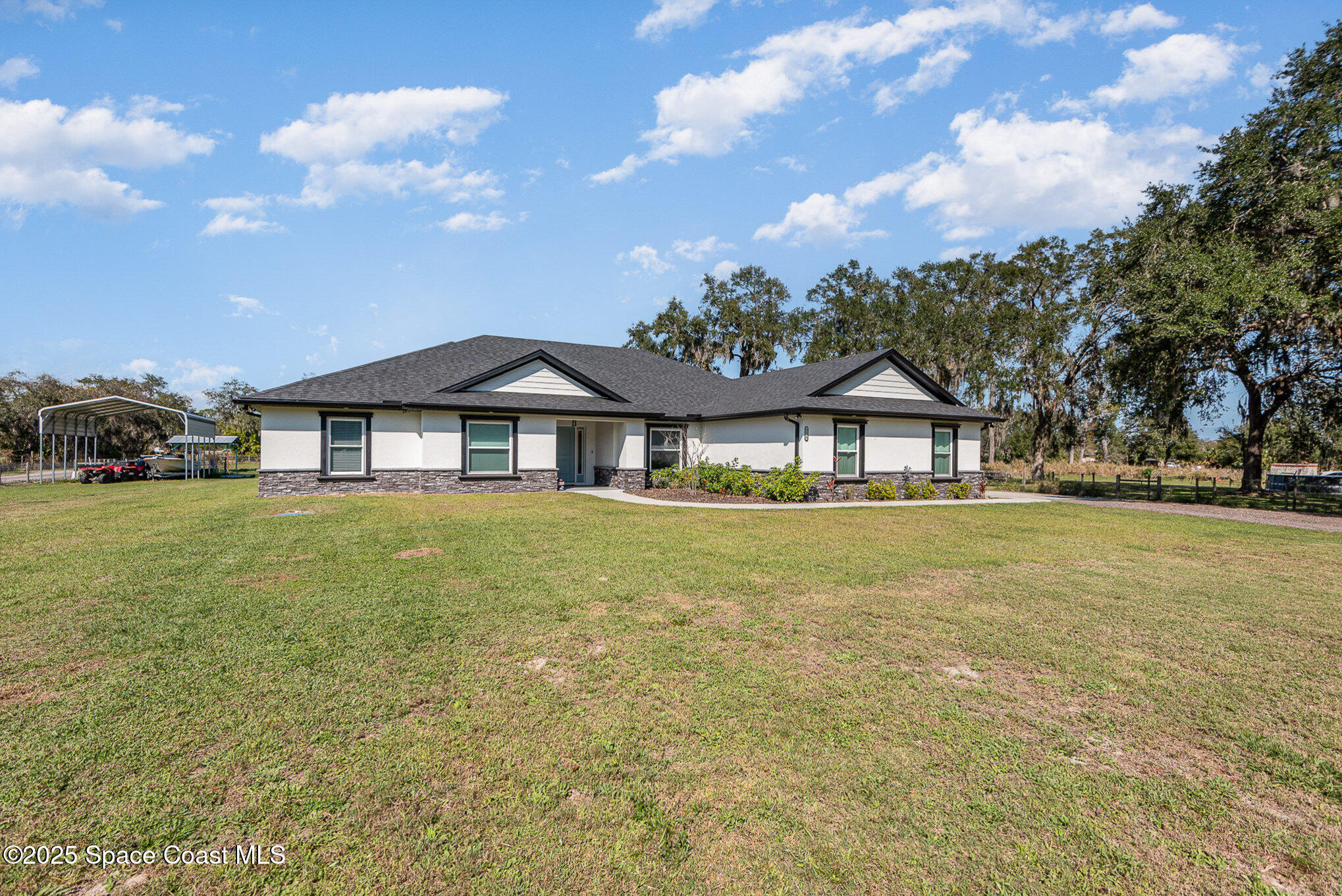 3620 Maebert Road Mims, FL 32754 - Photo 3 of 35 a front view of a house with a garden