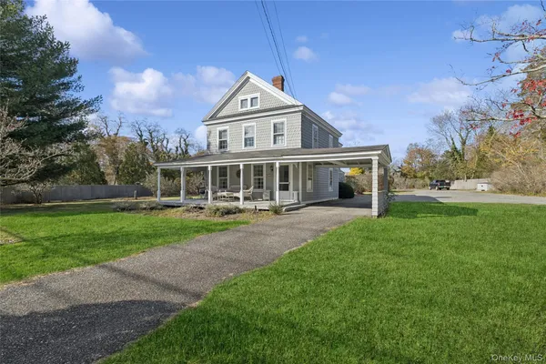 a front view of a house with a yard table and chairs