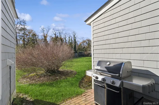 a backyard of a house with outdoor seating