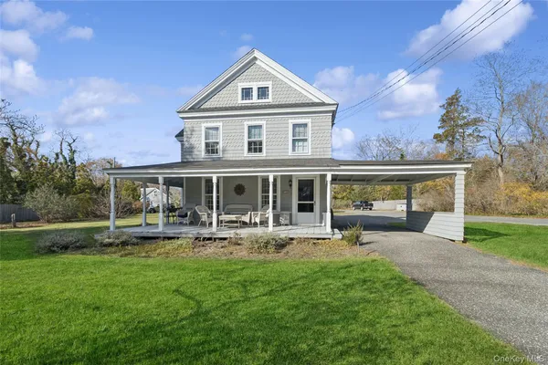 a front view of a house with garden and porch