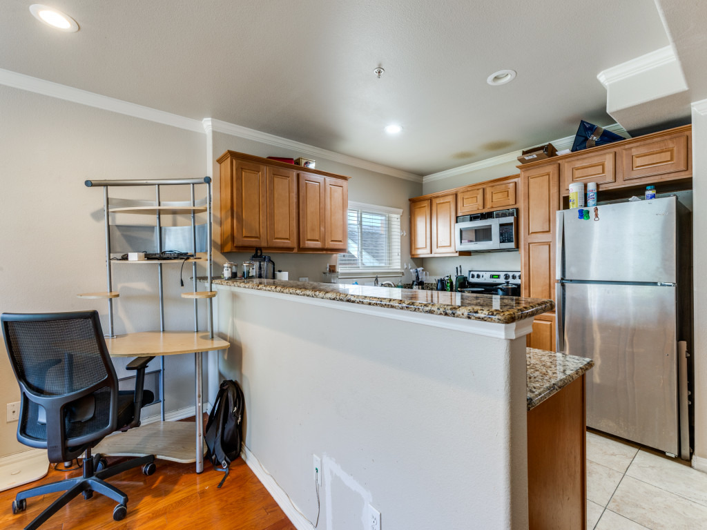 3007 Speedway, Unit 4 Austin, TX 78705 - Photo 13 of 25 a kitchen with stainless steel appliances a refrigerator a stove a sink dishwasher and a refrigerator with wooden floor
