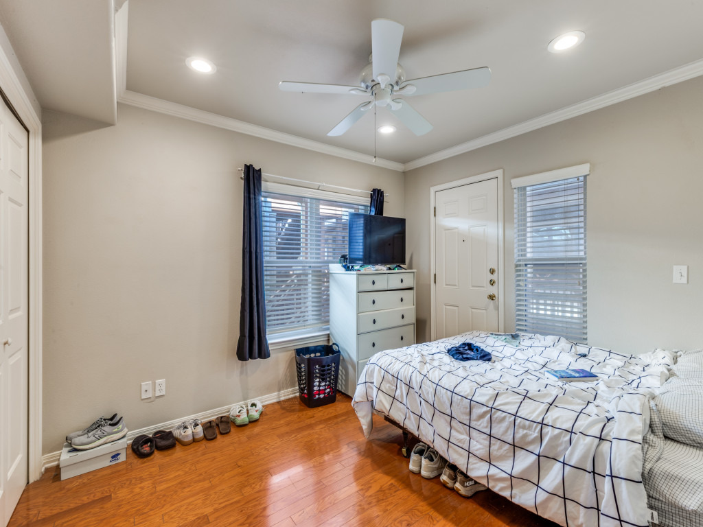 3007 Speedway, Unit 4 Austin, TX 78705 - Photo 16 of 25 a bedroom with a bed and a view of kitchen