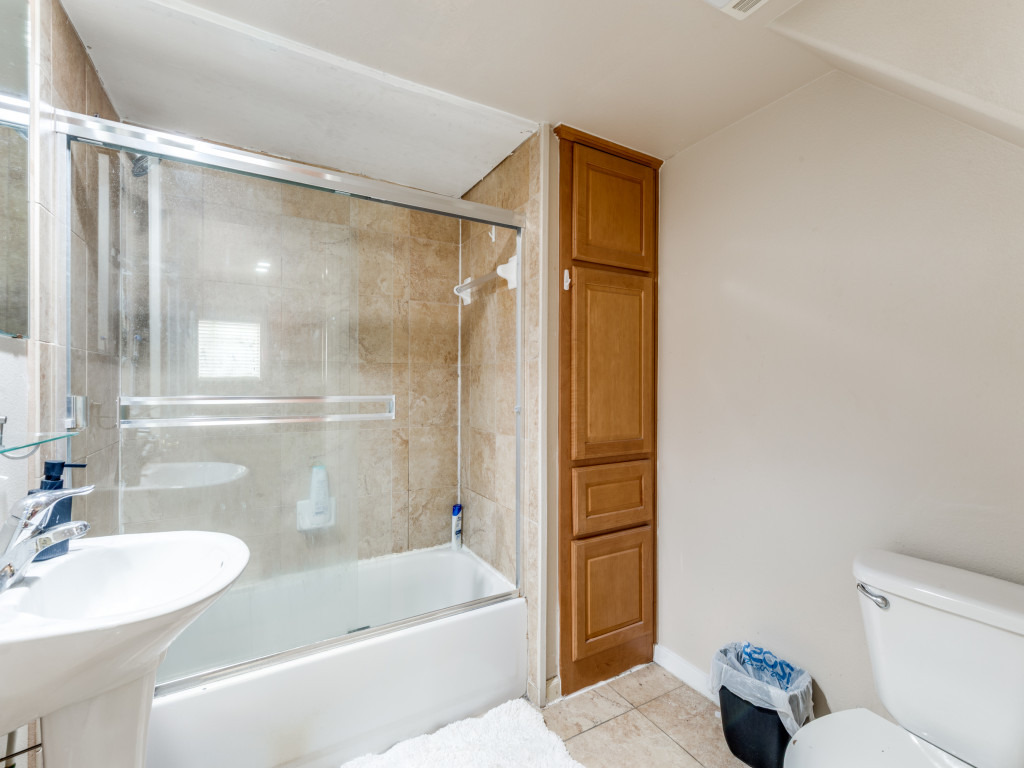 3007 Speedway, Unit 4 Austin, TX 78705 - Photo 17 of 25 a bathroom with a sink toilet and shower