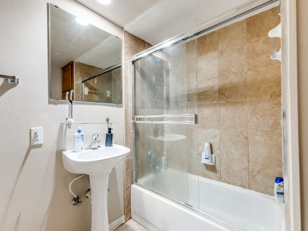 3007 Speedway, Unit 4 Austin, TX 78705 - Photo 18 of 25 a bathroom with a sink mirror and shower