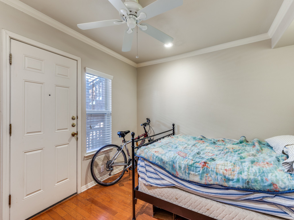 3007 Speedway, Unit 4 Austin, TX 78705 - Photo 20 of 25 a bedroom with a bed and wooden floor