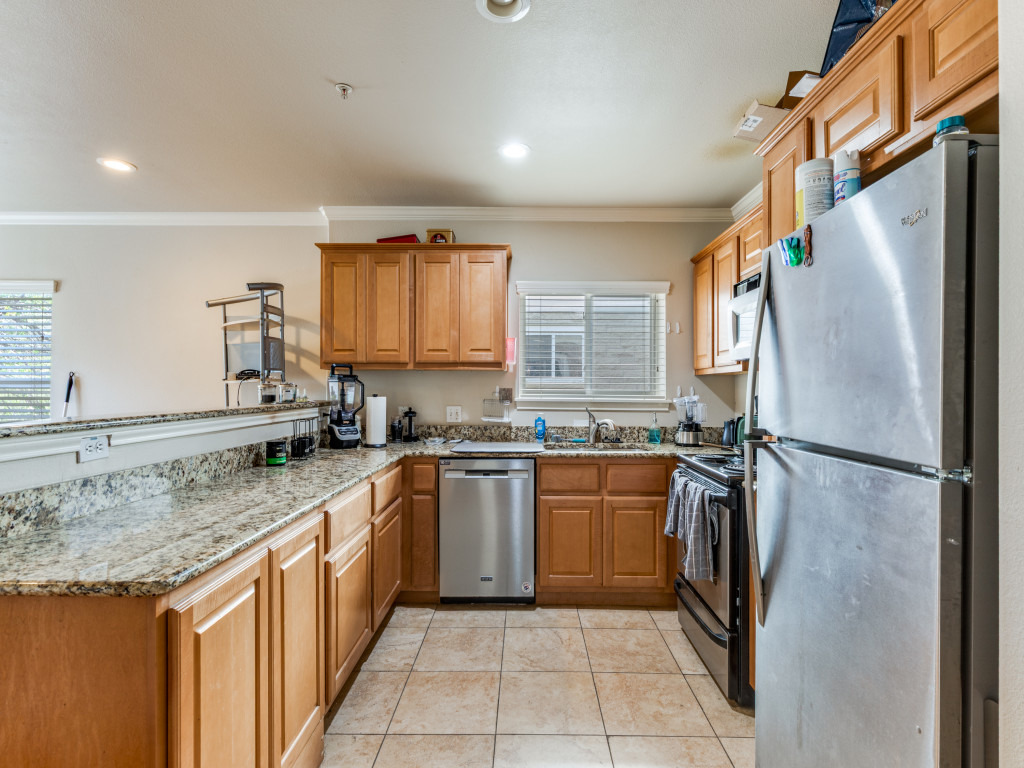 3007 Speedway, Unit 4 Austin, TX 78705 - Photo 4 of 25 a kitchen with stainless steel appliances granite countertop a refrigerator and a sink