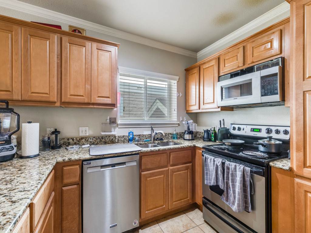 3007 Speedway, Unit 4 Austin, TX 78705 - Photo 6 of 25 a kitchen with stainless steel appliances granite countertop a sink stove cabinets and a window