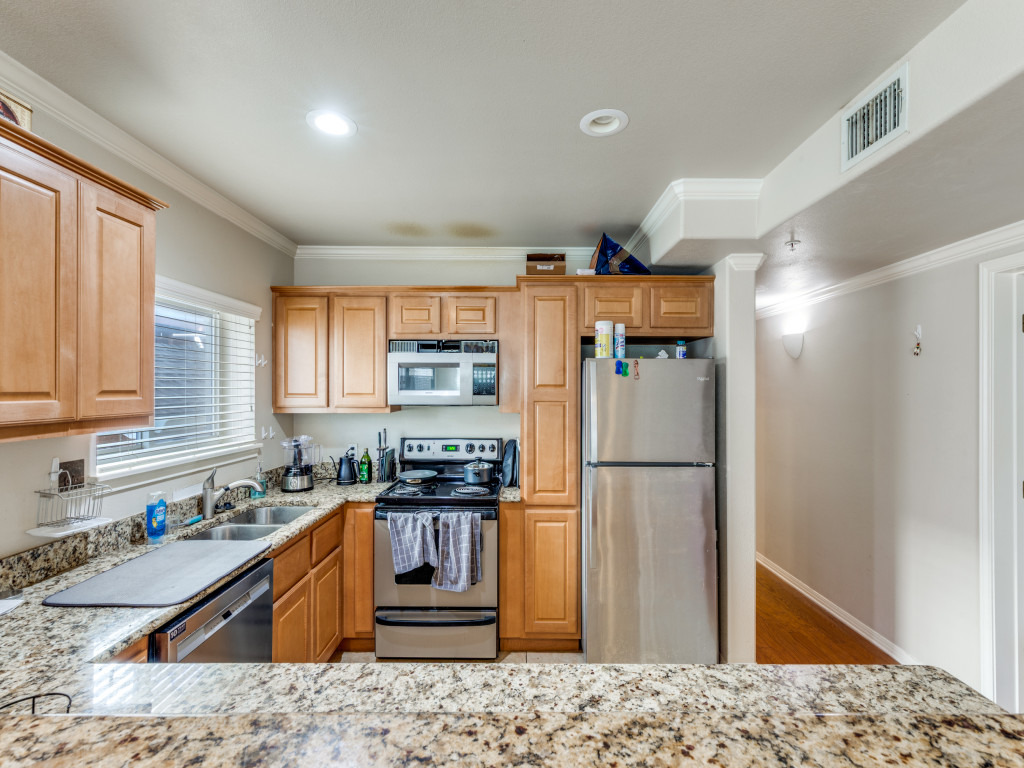 3007 Speedway, Unit 4 Austin, TX 78705 - Photo 10 of 25 a kitchen with granite countertop a refrigerator and a sink