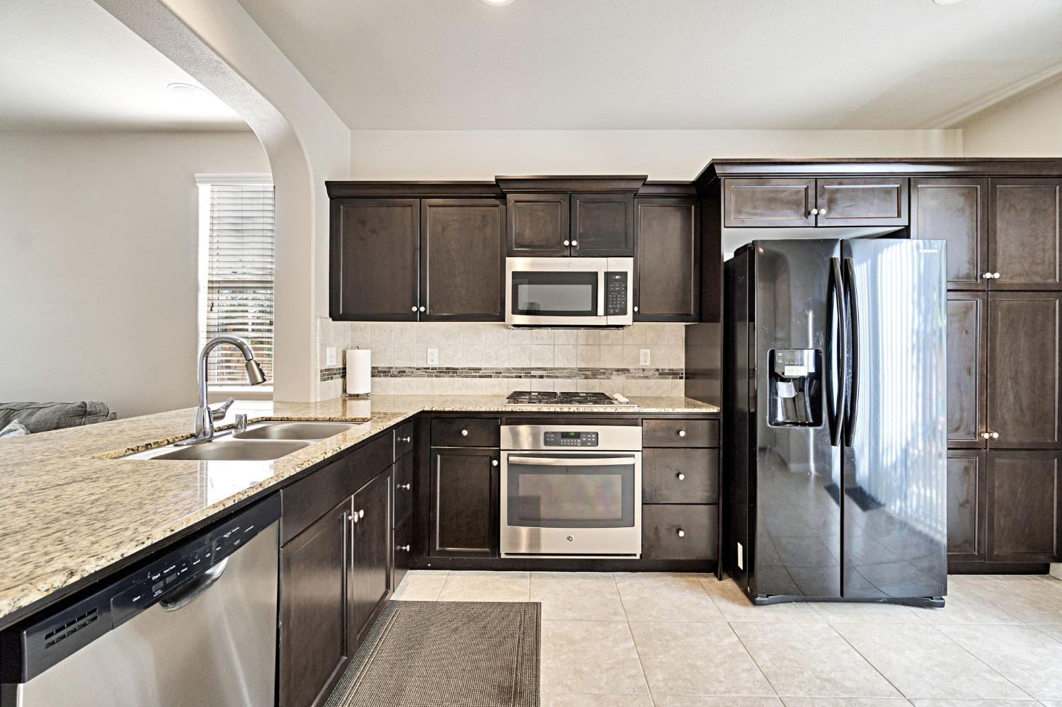 1500 North Encoure Way Clovis, CA 93619 - Photo 11 of 37 a kitchen with a sink stove and refrigerator